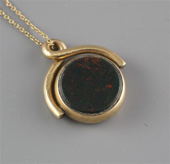 A late Victorian 9ct, bloodstone and carnelian set spinning fob, on an associated yellow metal chain,